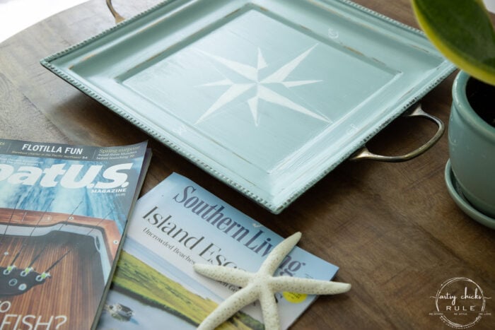 magazines on wood table with aqua tray