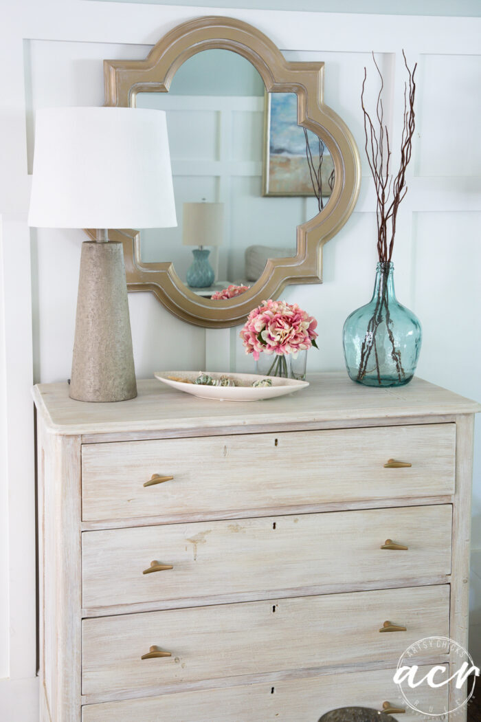 dresser with new lamp mirror blue jar and pink flowers