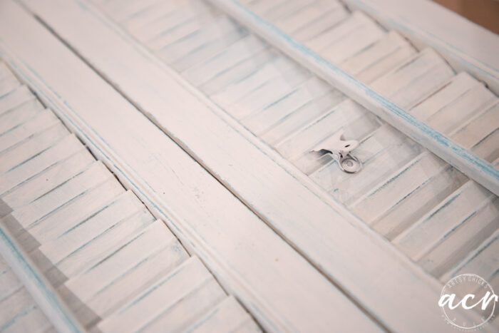 white shutters distressed with blue underneath