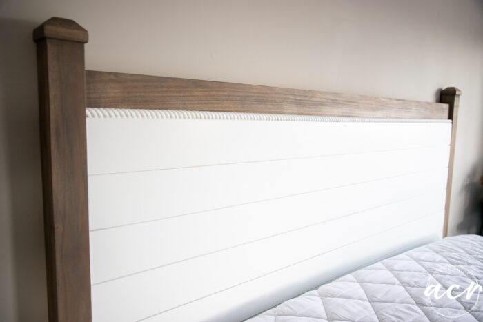 white painted shiplap headboard on wall