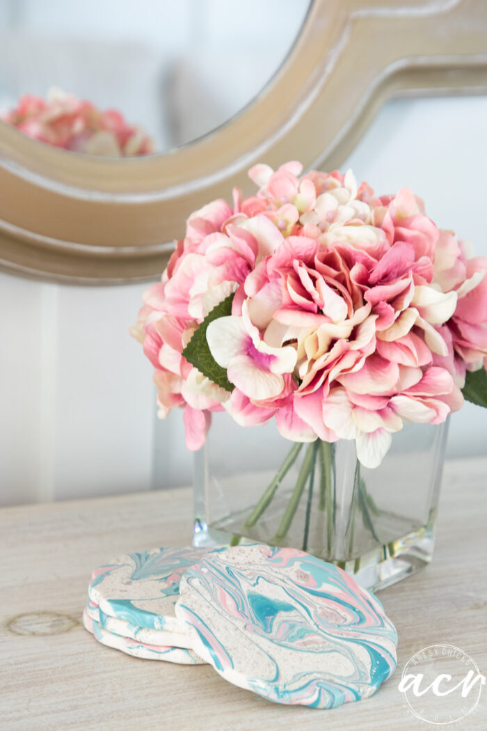 pink flowers on dresser with coasters