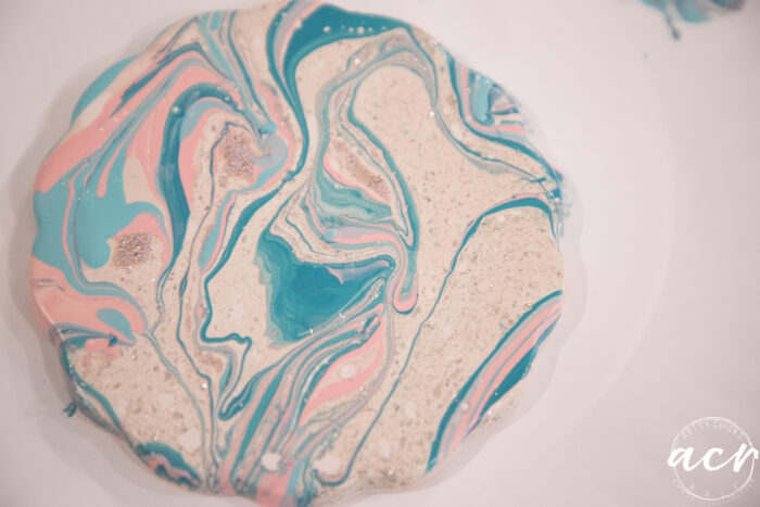 finished coaster with swirled blue and pink polish