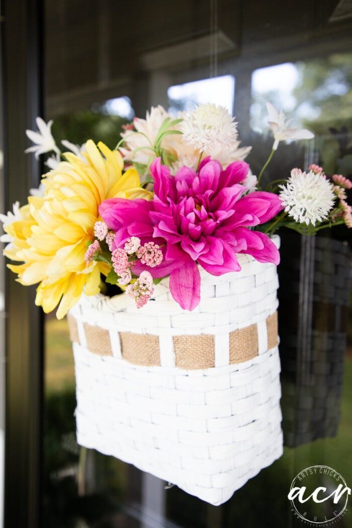 hot pink and yellow flowers in white basket