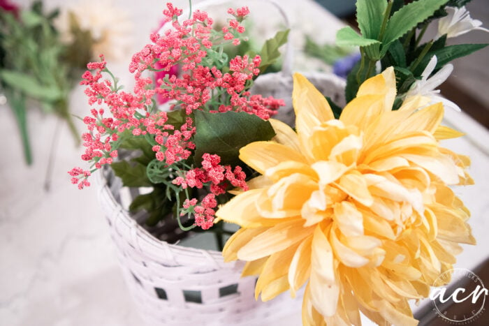 arranging the florals in the basket