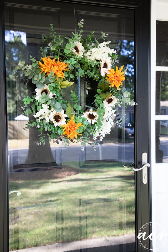 glass storm door with fall wreath