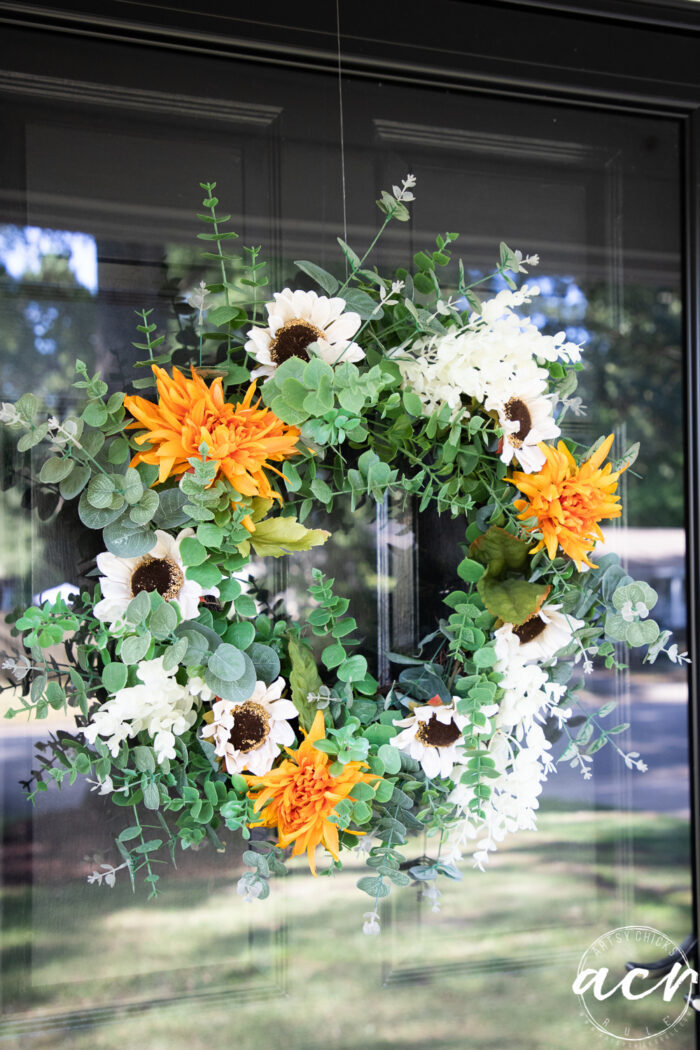 up close of green, white and orange fall wreath