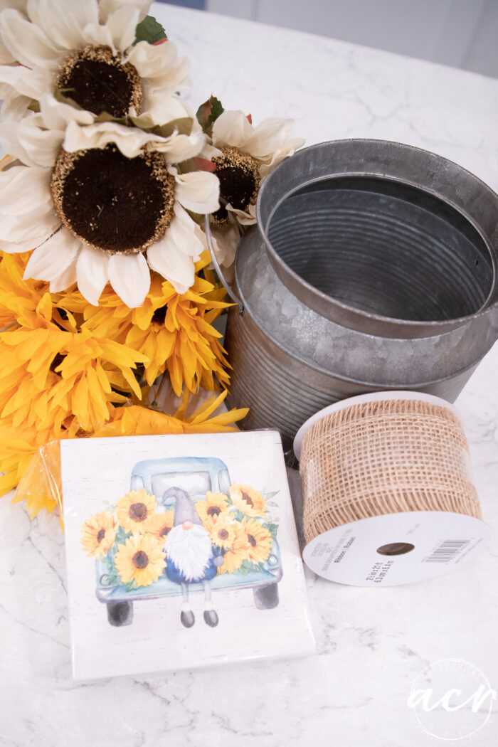 tin, burlap ribbon, knome napkin, yellow and white sunflowers