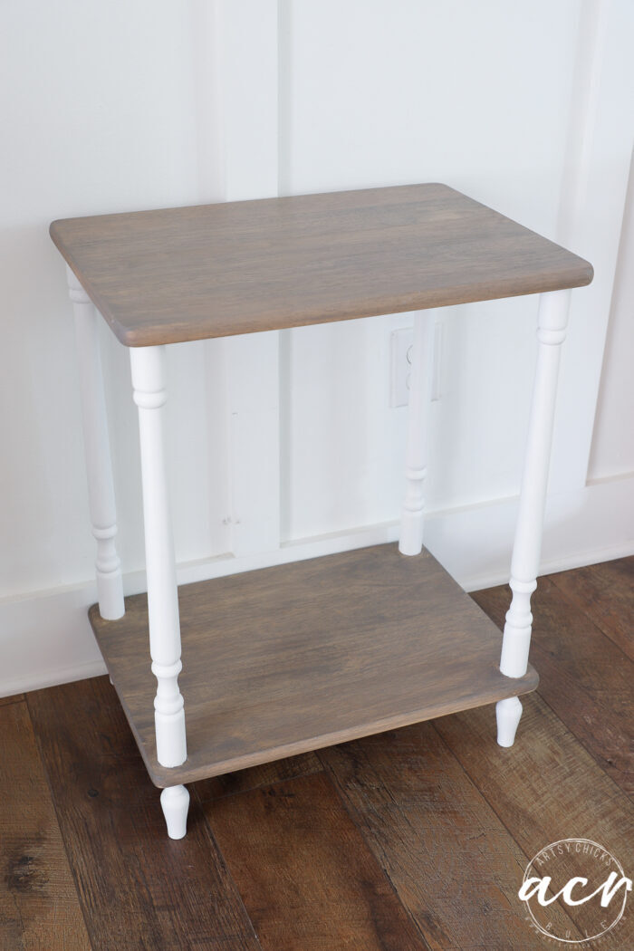 side view of driftwood stained table with white legs