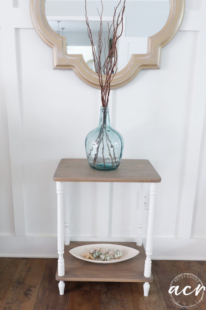 two tiered table with stained shelves and white legs