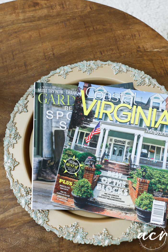 wood table with gold tray and magazines