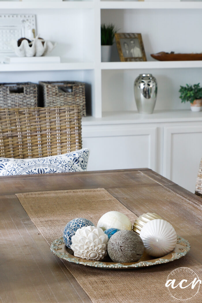 dining table with decorative balls on gold patina'd tray