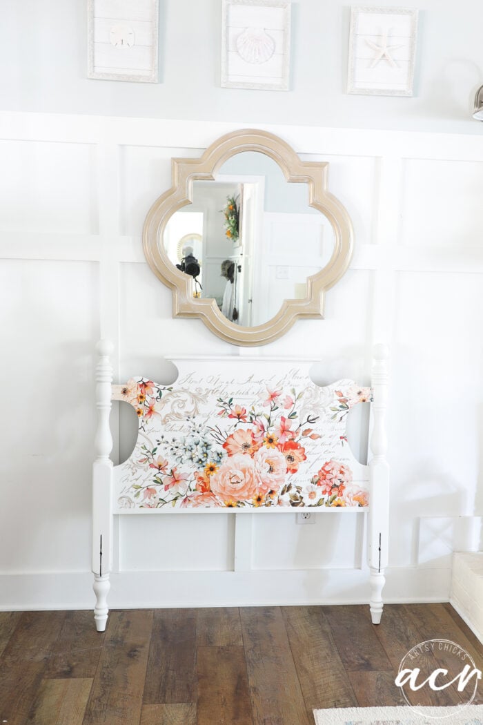 white headboard with gold mirror on wall