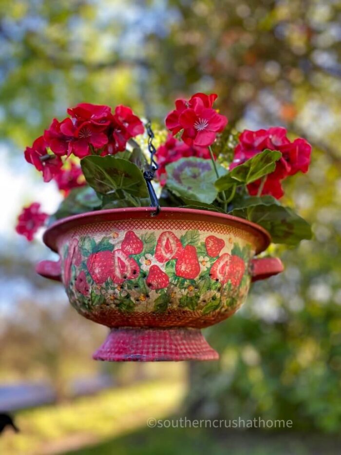 red flowers in red napkin decoupaged colander