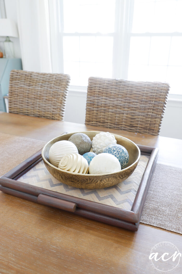 dining table with wood tray and metal bowl balls