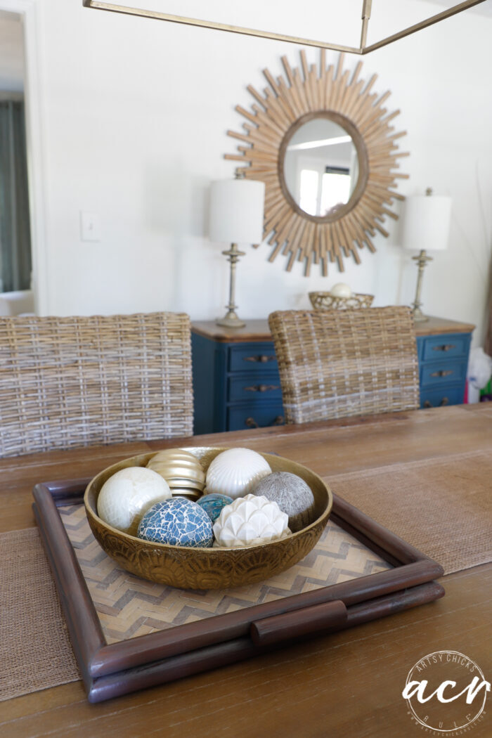 dining room with stained wood tray blue dresser mirror on wall