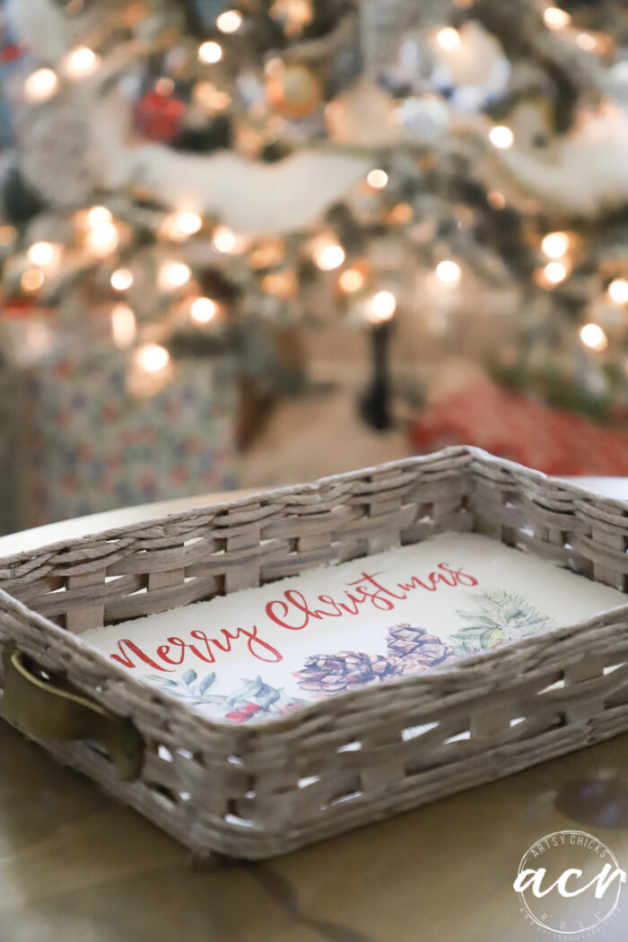 Merry Christmas tray with Christmas tree and lights behind it