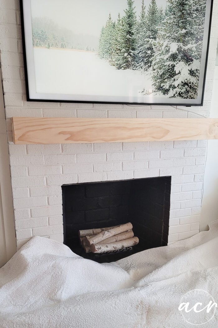 unfinished wood mantel on fireplace