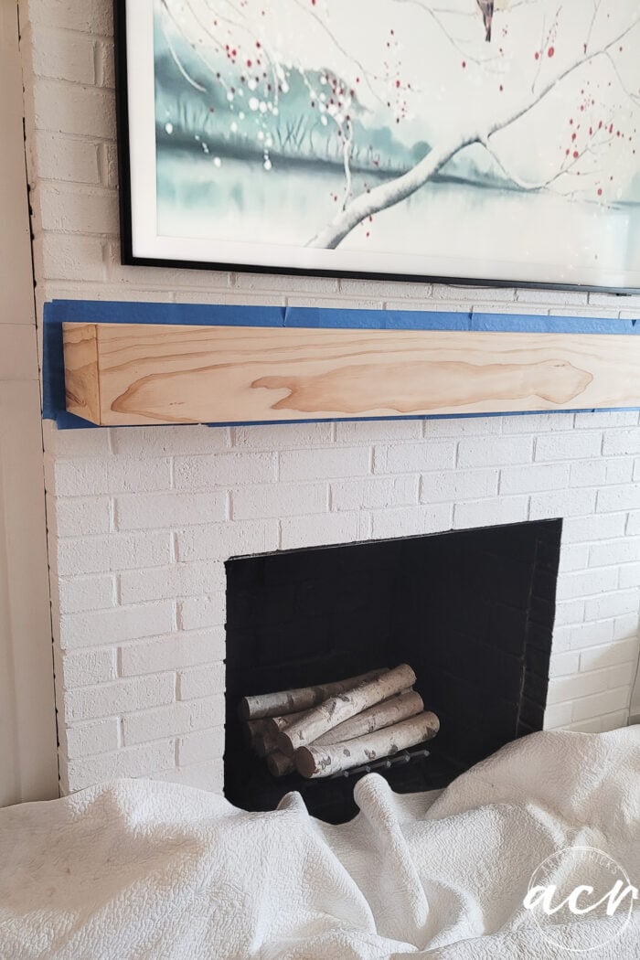 wood mantel taped for staining