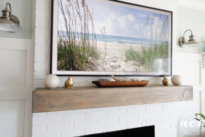 decorated wood mantel and tv over top