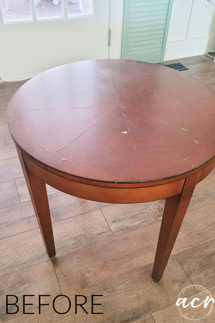 reddish colored round stained table before