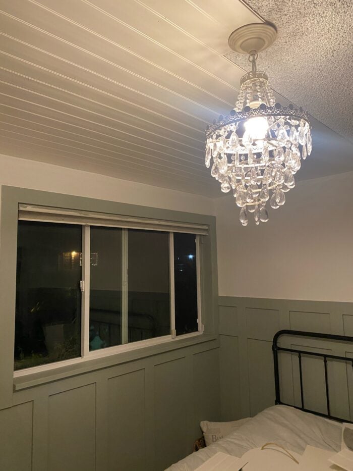 bedroom with green walls and white beadboard ceiling