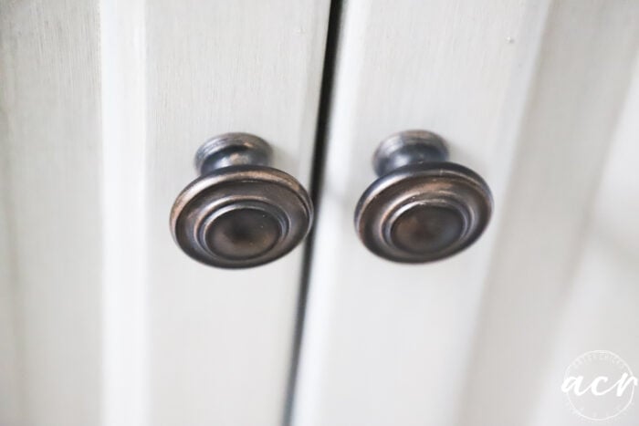 up close top view of 2 round bronze colored knobs