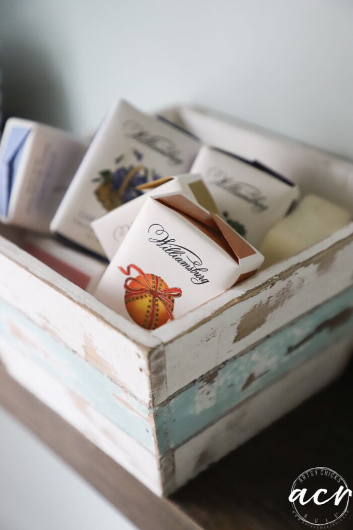 up close wood bowl with packaged small soaps inside