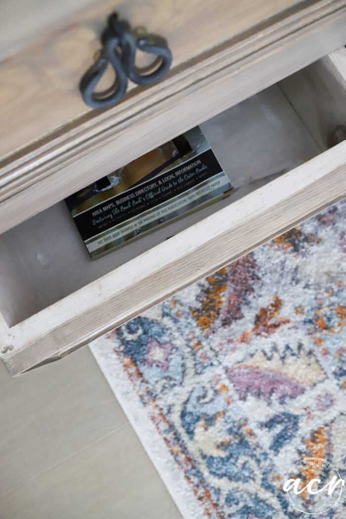 looking inside open drawer of nightstand