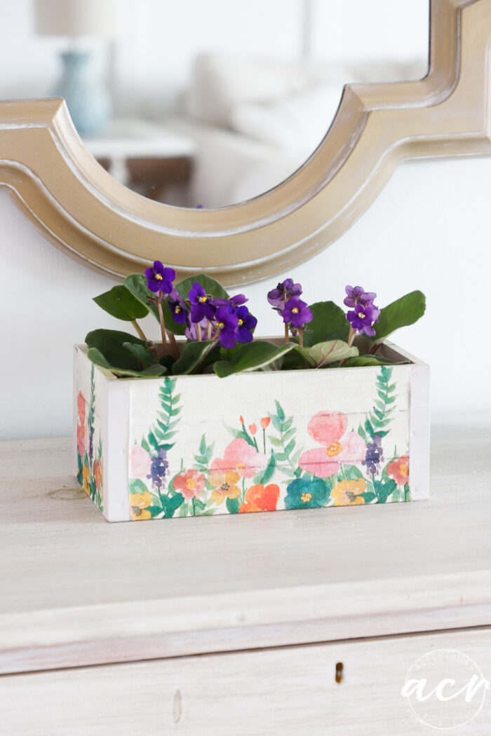 small box with floral decoupage on sides and flowers inside box