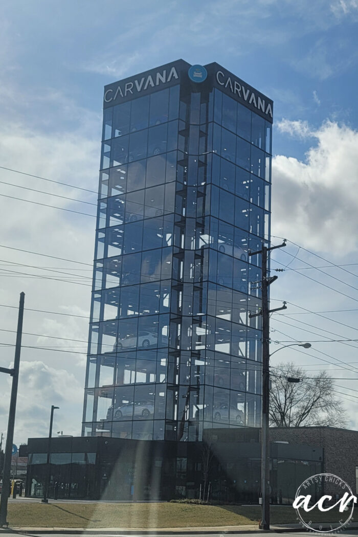 tall carvana glass building with cars inside