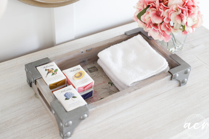 decorative tray with soaps and white washcloths