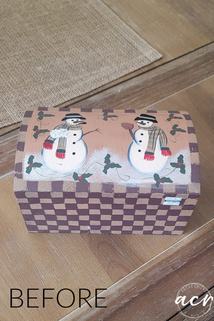 beige box with two snowman painted on top