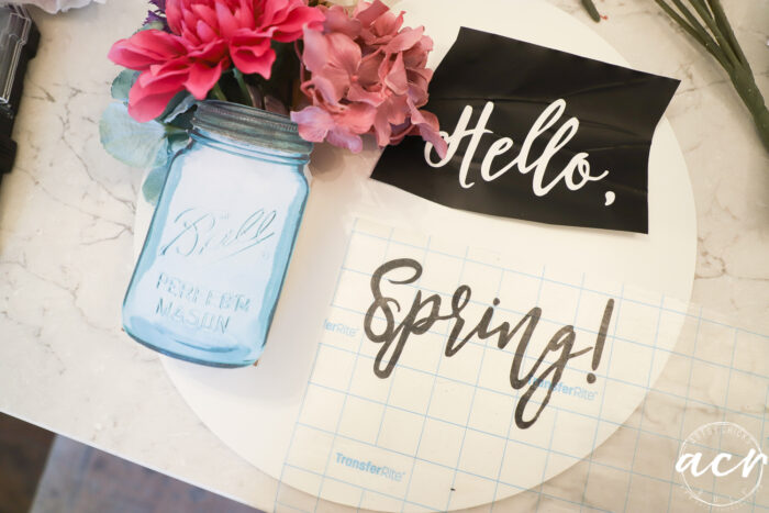 hello spring sign with blue mason jar, flowers and vinyl lettering