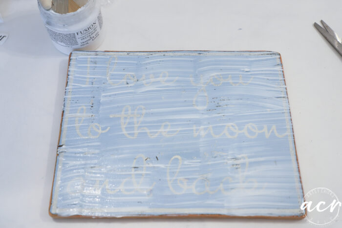 blue sign with decoupage gel applied