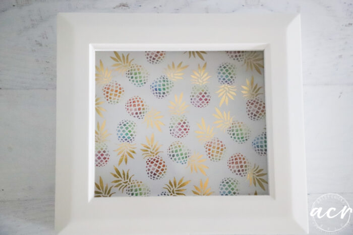 small white box with colorful pineapple paper on bottom