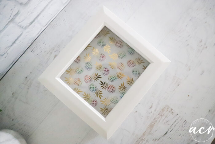 top view of white box with colorful pineapple paper