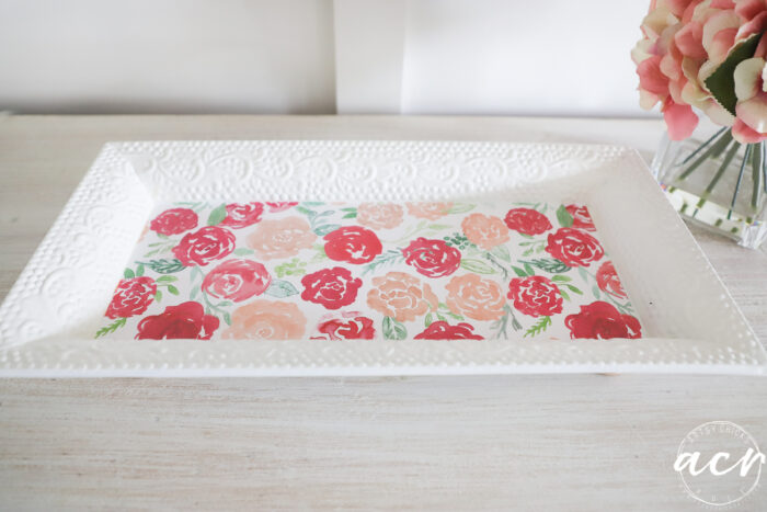 white tray with varying shades of pink flowers