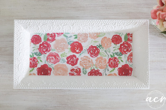 white tray with pink floral decoupaged paper on table top