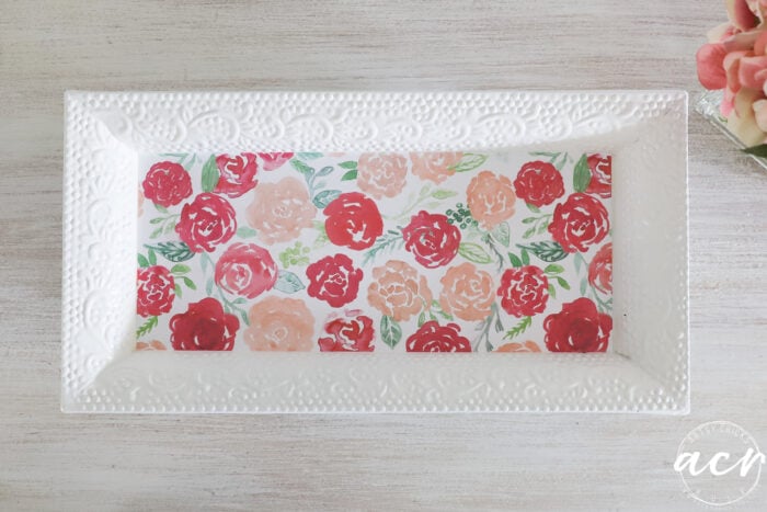 white tray with pink floral decoupaged paper on table top