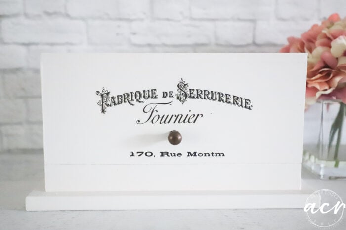 front view of white box with French decor transfers (writing)