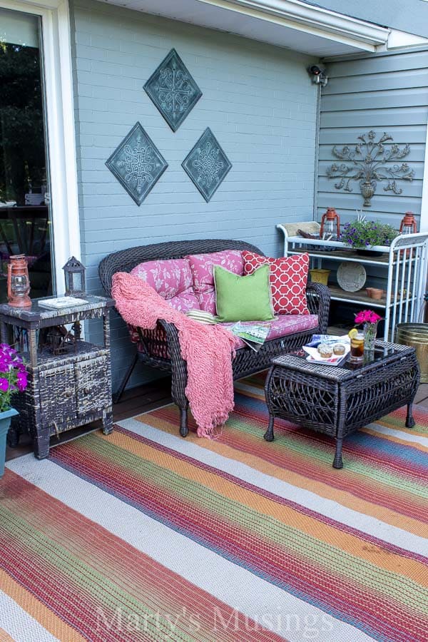 colorful rug on deck with pink couch