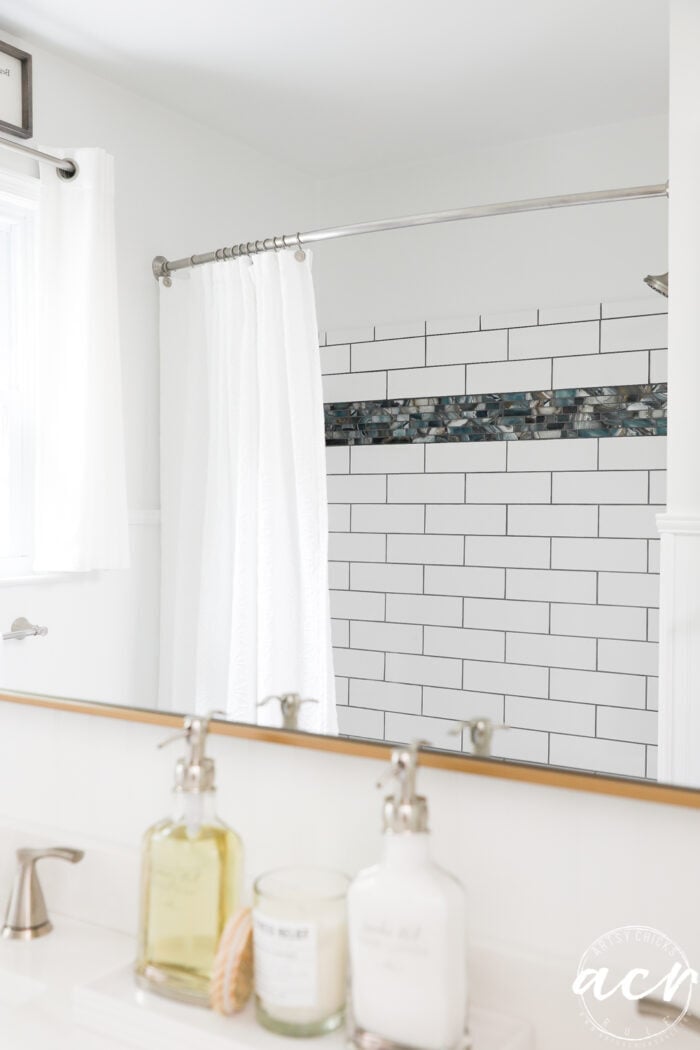 tiled shower in reflection of mirror