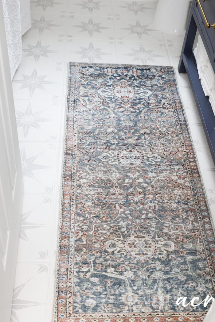 multi color blue rug on stenciled and painted floor