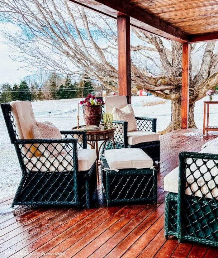 black furniture white cushions wood deck porch