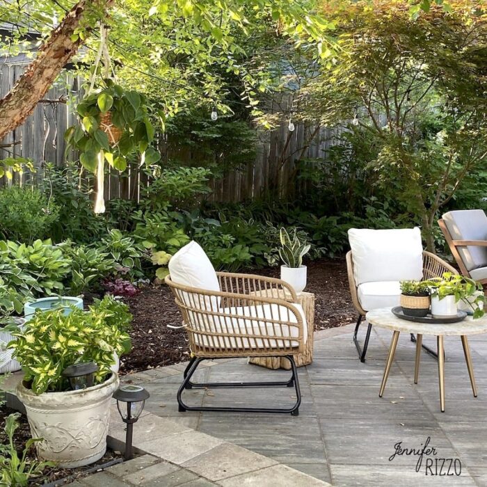garden surrounded patio with white furniture