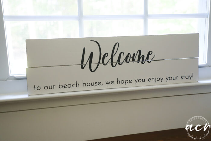 white welcome sign in window