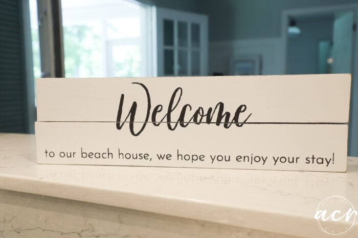 white sign with welcome on front