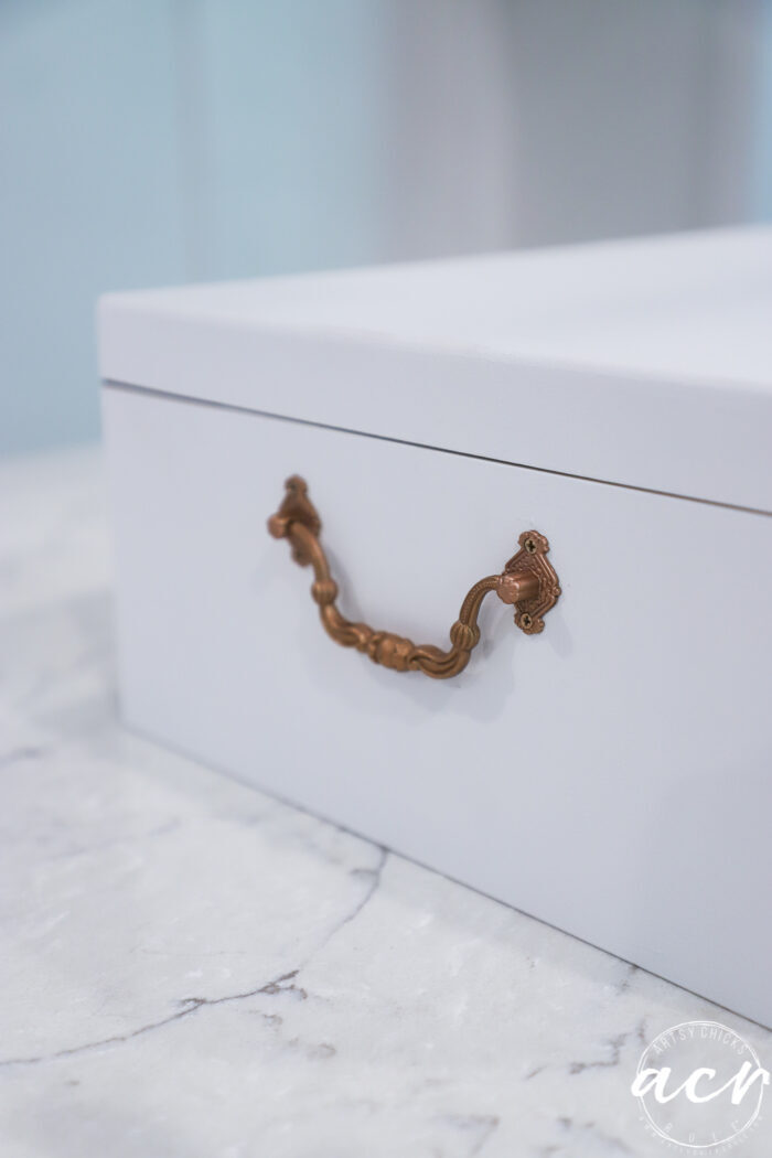 white box side view with copper color handle