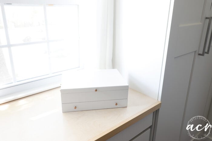 white flatware box on wood top with window