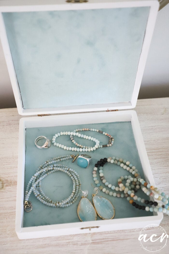 white box, blue fabric and aqua jewelry